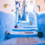 The blue city Morocco stairwell lined with clay potted plants