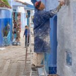 The blue city Morocco painter painting the blue walls