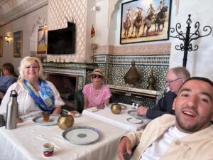 Omar and clients dining at an authentic Moroccan restaurant