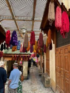 Dyed yarn hanging from ceiling in Moroccan market